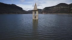 Der Glockenturm einer romanischen Kirche aus dem 11. Jahrhundert ragt aus dem Sau-Stausee in Vilanova de Sau, Spanien, am Montag, 24. März 2025. (AP Photo/Emilio Morenatti)
