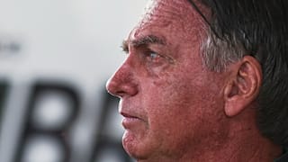 Brazil's former President Jair Bolsonaro speaks to the press after arriving at the international airport in Brasilia, 25 March, 2025