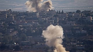Smoke and explosions from the fighting between forces loyal to Syrian President Bashar Assad and rebels rise in the village of Jubata al-Khashab as seen from the Israeli-contr