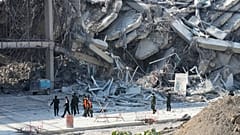 Des sauveteurs marchent sur le site d'une tour en construction qui s'est effondrée après un tremblement de terre de magnitude 7,7 à Bangkok, Thaïlande, vendredi 28 mars 2025.