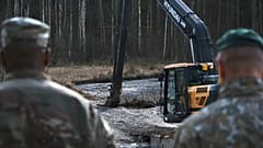 US and Lithuanian army personnel work to retrieve a US Army Hercules armoured vehicle near a training area near Pabadre, 27 March 2025