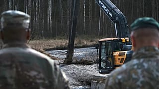 US and Lithuanian army personnel work to retrieve a US Army Hercules armoured vehicle near a training area near Pabadre, 27 March 2025