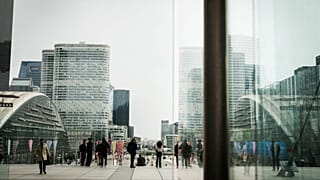 People stroll in La Defense business district outside Paris. 21 March 2025.