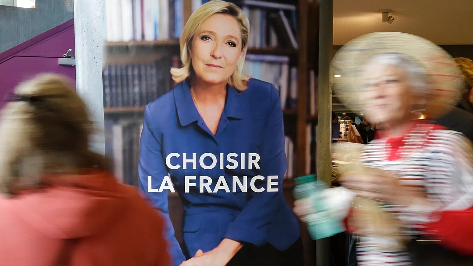 FILE: Two women pass an election poster for French far-right leader and presidential candidate Marine Le Pen which reads "Choose France" in Nice, 27 April 2017.
