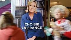 FILE: Two women pass an election poster for French far-right leader and presidential candidate Marine Le Pen which reads "Choose France" in Nice, 27 April 2017.