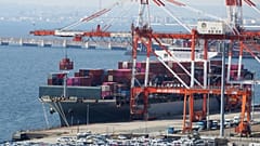 A container ship is loaded and unloaded at a container terminal at a port of Kawasaki near Tokyo. 9 March 2022.