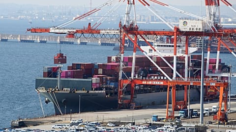 A container ship is loaded and unloaded at a container terminal at a port of Kawasaki near Tokyo. 9 March 2022.