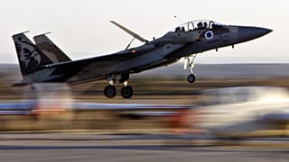 An Israeli Air Force fighter plane lands during an acrobatics display at a graduation ceremony at the Hatzerim Air Force Base near the southern Israeli city of Beersheba, Thur