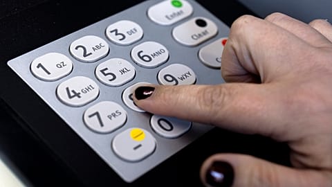 A woman uses an ATM outside a bank in Portland, OR, 12 November 2024