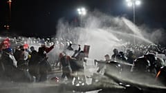 Riot police officers clash with protesters during a protest in Istanbul, 23 March, 2025