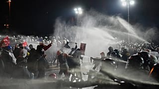 Riot police officers clash with protesters during a protest in Istanbul, 23 March, 2025