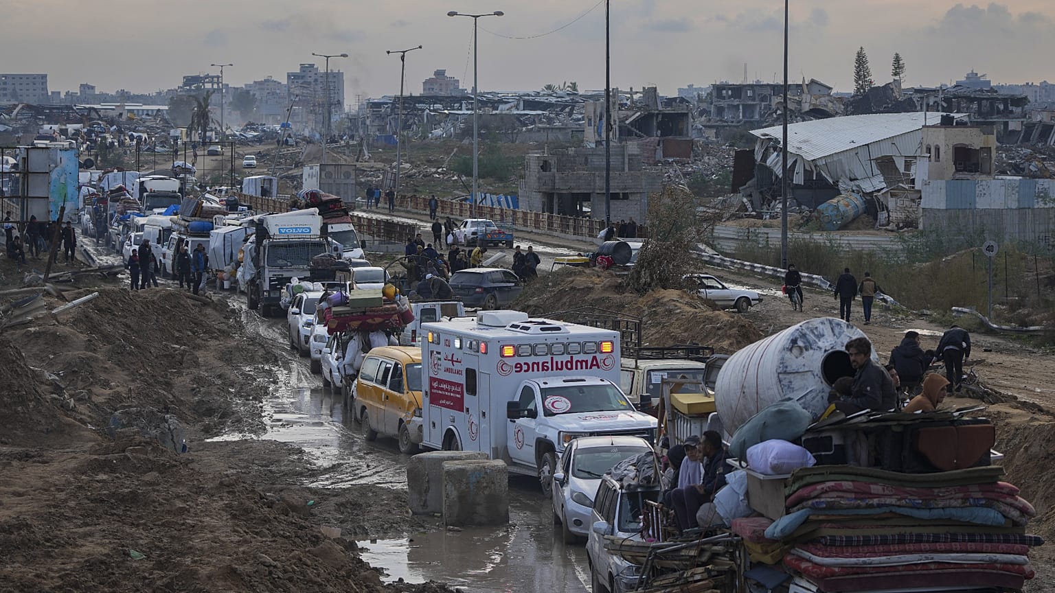 Displaced Palestinians wait at a security checkpoint in the Netzarim Corridor while traveling to the north of Gaza, 11 February, 2025