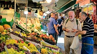 A man shops in a market in Istanbul, Monday, Aug. 13, 2018. 