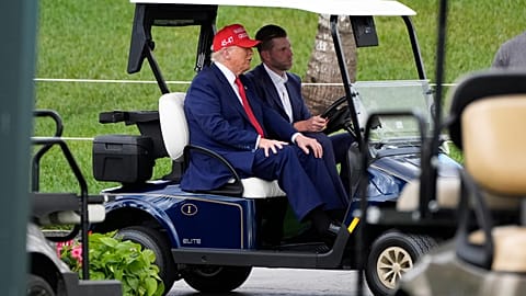 President Donald Trump, driven by his son Eric Trump, arrives at Trump National Doral during the LIV Golf Miami tournament. 3 April 2025.