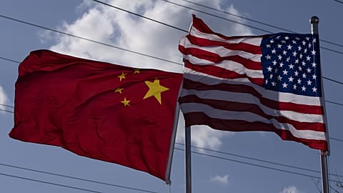 Chinese and United States flags are flown outside the China International Supply Chain Expo in Beijing, 27 November, 2024