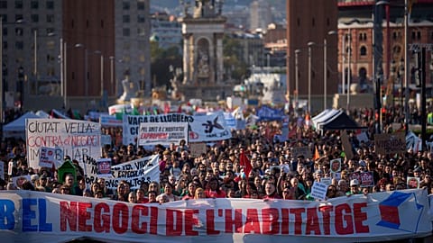 People gather during a demonstration to protest high housing costs in Barcelona, Spain, Saturday, April 5, 2025.