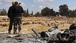 ضابطان في الجيش السوري يتفقدان موقع غارة إسرائيلية على قاعدة جوية عسكرية بالقرب من حماة ، سوريا ، الخميس 3 أبريل 2025