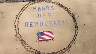 Protesters form a human banner on Ocean Beach during a protest against President Donald Trump, part of the "Hands Off" rallies held nationwide, San Francisco, April 5, 2025