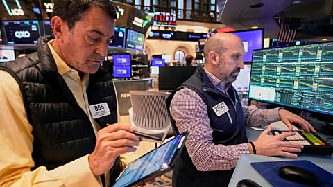 Trader Mark Muller and Specialist James Denaro work on the floor of the New York Stock Exchange, Friday, April 4, 2025. 