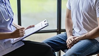 A patient discusses test results with his doctor.