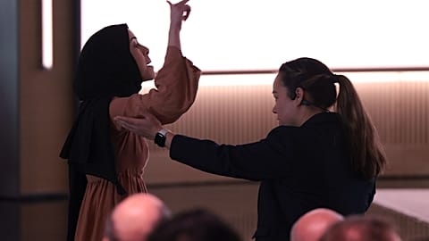 A pro-Palestinian demonstrator, Ibtihal Aboussad, is escorted away by security as they interrupt Microsoft AI CEO Mustafa Suleyman during a presentation.