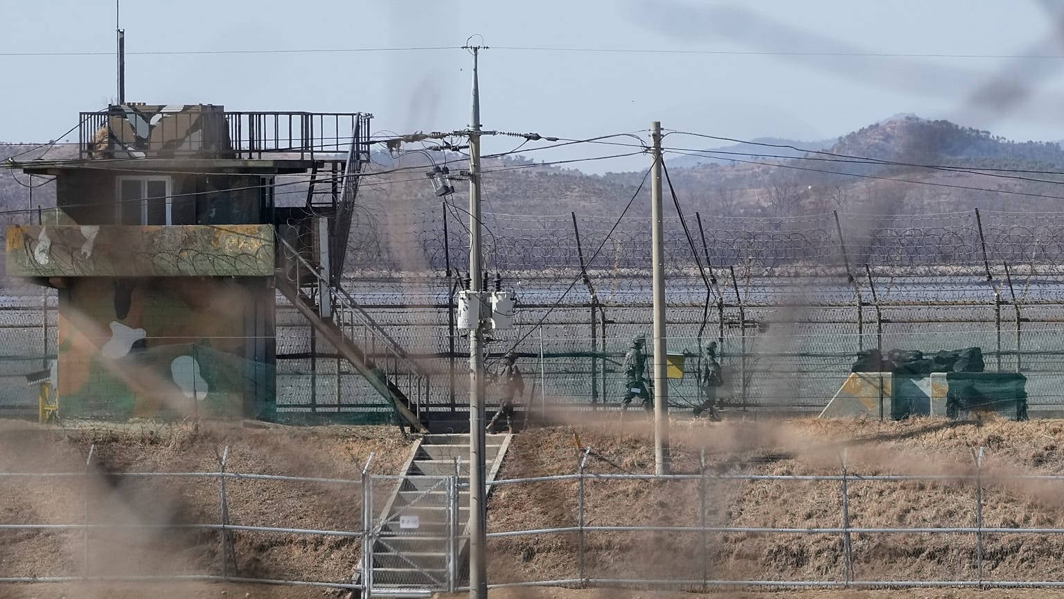 Güney Kore askerleri, Kuzey Kore sınırına yakın Paju kentinde dikenli tellerle çevrili bir çitte devriye gezerken, 18 Şubat 2025