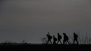Migrants walk to enter Greece from Turkey by crossing the Maritsa River, 1 March, 2020