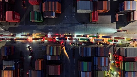 Trucks line up to depart from a container terminal in Nanjing in east China's Jiangsu province on Tuesday, April 8, 2025.