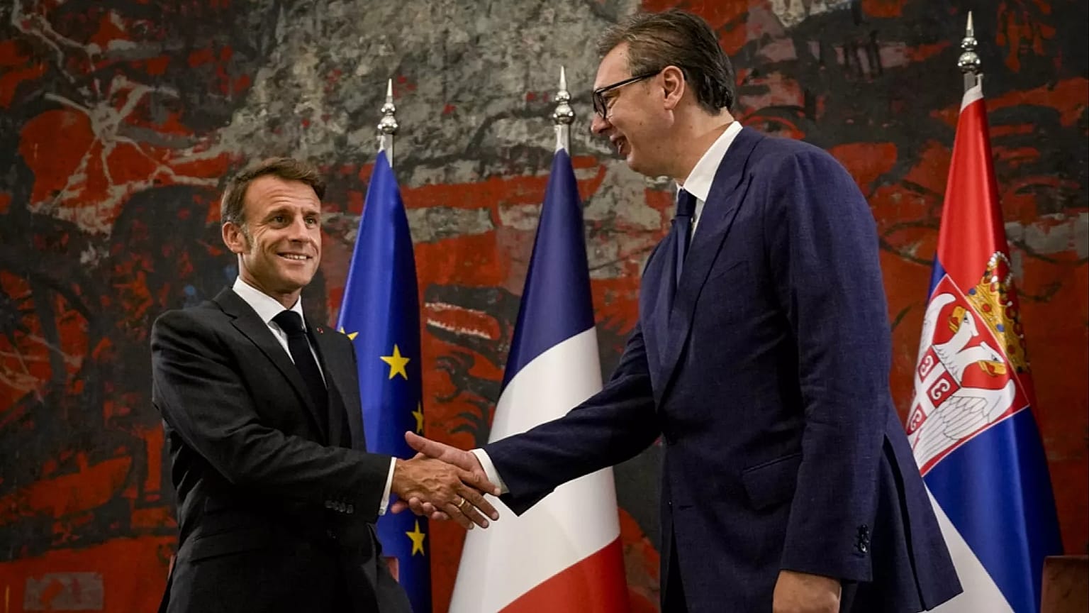 FILE - French President Emmanuel Macron, left, shakes hands with Serbian President Aleksandar Vucic in Belgrade, Serbia, Thursday, Aug. 29, 2024. 