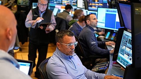 Traders work on the floor at the New York Stock Exchange in New York, Wednesday, April 9, 2025. 
