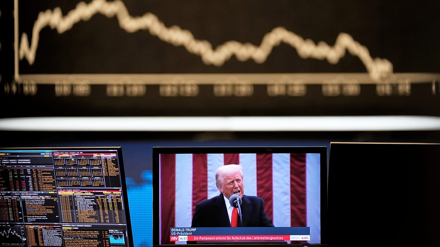 US President Donald Trump appears on a television screen at the stock market in Frankfurt, 3 April, 2025