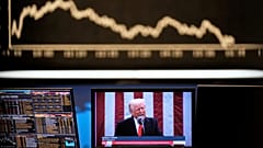 US President Donald Trump appears on a television screen at the stock market in Frankfurt, 3 April, 2025