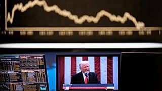 US President Donald Trump appears on a television screen at the stock market in Frankfurt, 3 April, 2025
