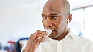 A man gives a saliva sample for an at-home test.
