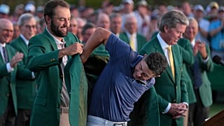 Scottie Scheffler puts the green Jacket on winner, Rory McIlroy, of Northern Ireland, at the Masters golf tournament, Sunday, April 13, 2025, in Augusta