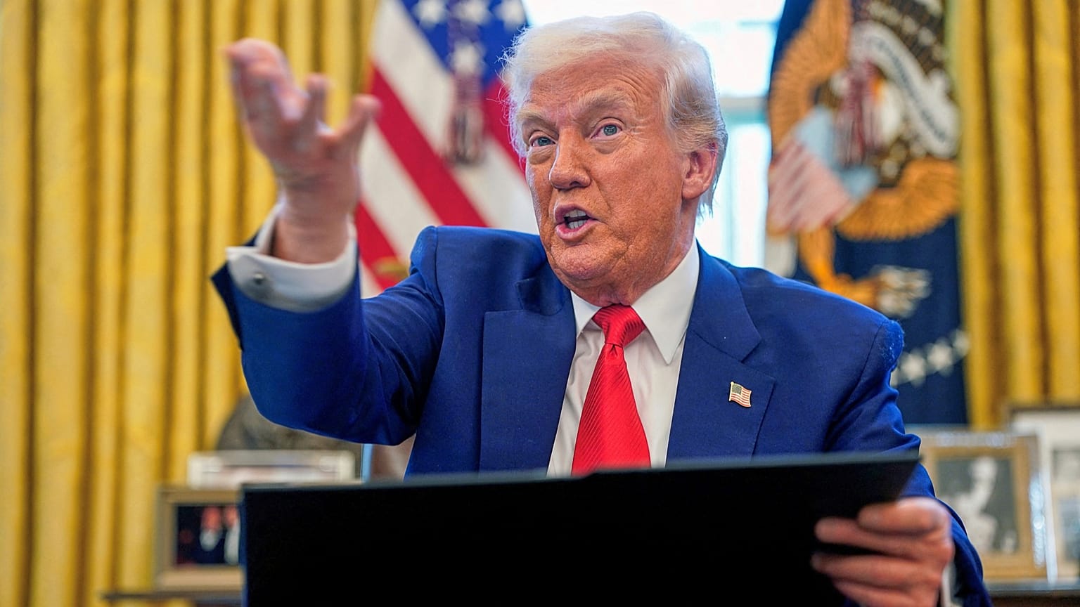 US President Donald Trump speaks as he signs executive orders in the Oval Office of the White House, 9 April 2025