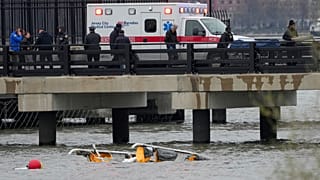 Emergency personnel work at the site of a helicopter crash on the Hudson River, Thursday, April 10, 2025, in Jersey City, N.J.