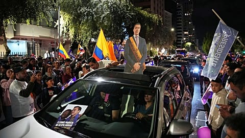 Supporters of President Daniel Noboa celebrate early returns showing him in the lead in the presidential election runoff in Quito, 13 April 2025
