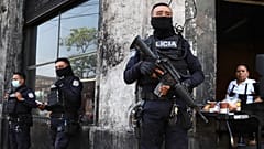 FILE: Heavily armed police guard the streets in downtown San Salvador, 27 March 2022