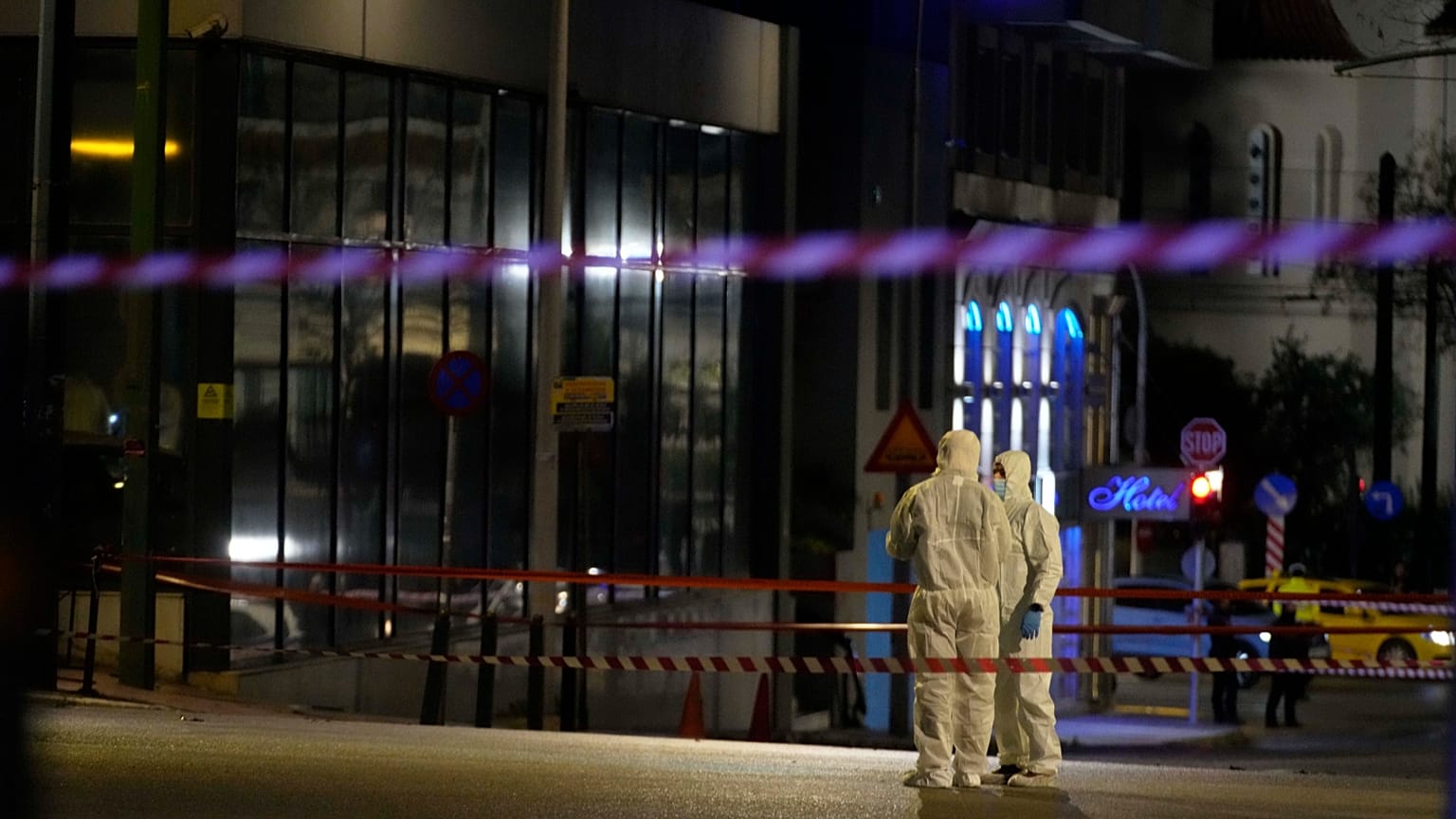 Police investigators inspect the site after a bomb explosion outside of the Hellenic Train offices in Athens, 11 April 2025