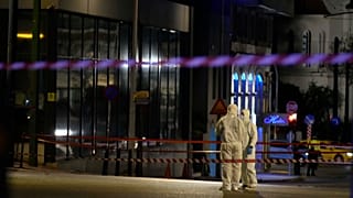 Police investigators inspect the site after a bomb explosion outside of the Hellenic Train offices in Athens, 11 April 2025