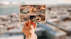Bir el, üzerinde İzlanda resimleri bulunan bir kartpostal tutuyor. 