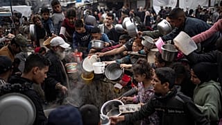 Palestinians line up for a meal in Rafah, 21 December, 2023