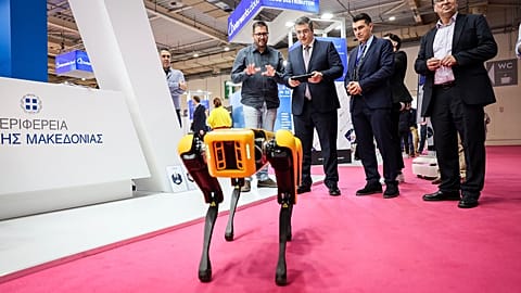 A robot at the Beyond 2025 exhibition in Greece, with EU Commissioner Apóstolos Tzitzikostas.