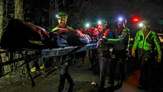 Rescuers recover the body of one of the victims of a cable car carrying tourists south of Naples which crashed after the cable snapped, 17 April, 2025