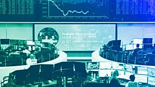 Stock market traders work behind their desks on the trading floor of the Frankfurt Stock Exchange, March 2025