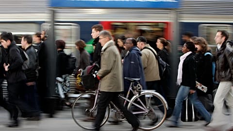 A commuter walks with his bike alongside a train at Paris' Saint Lazare station. 19 March 2009.