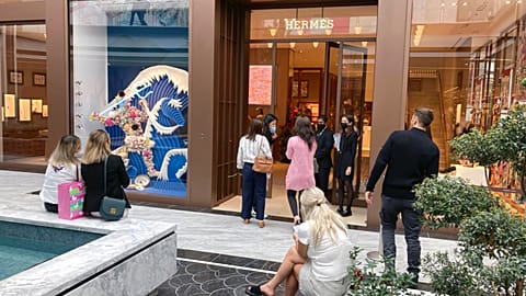 People shop at a Hermes store during the opening day of the luxury wing of the American Dream shopping mall in East Rutherford, New Jersey, 17 September 2021..