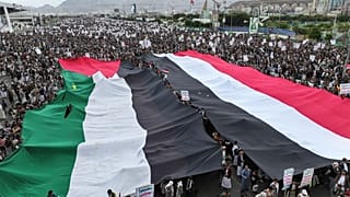 رفع المتظاهرون العلمين الفلسطيني واليمني خلال المسيرة