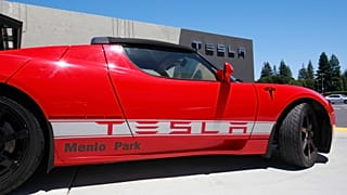File photo - A Tesla electric sport car is on display outside the showroom in Menlo Park, Calif.